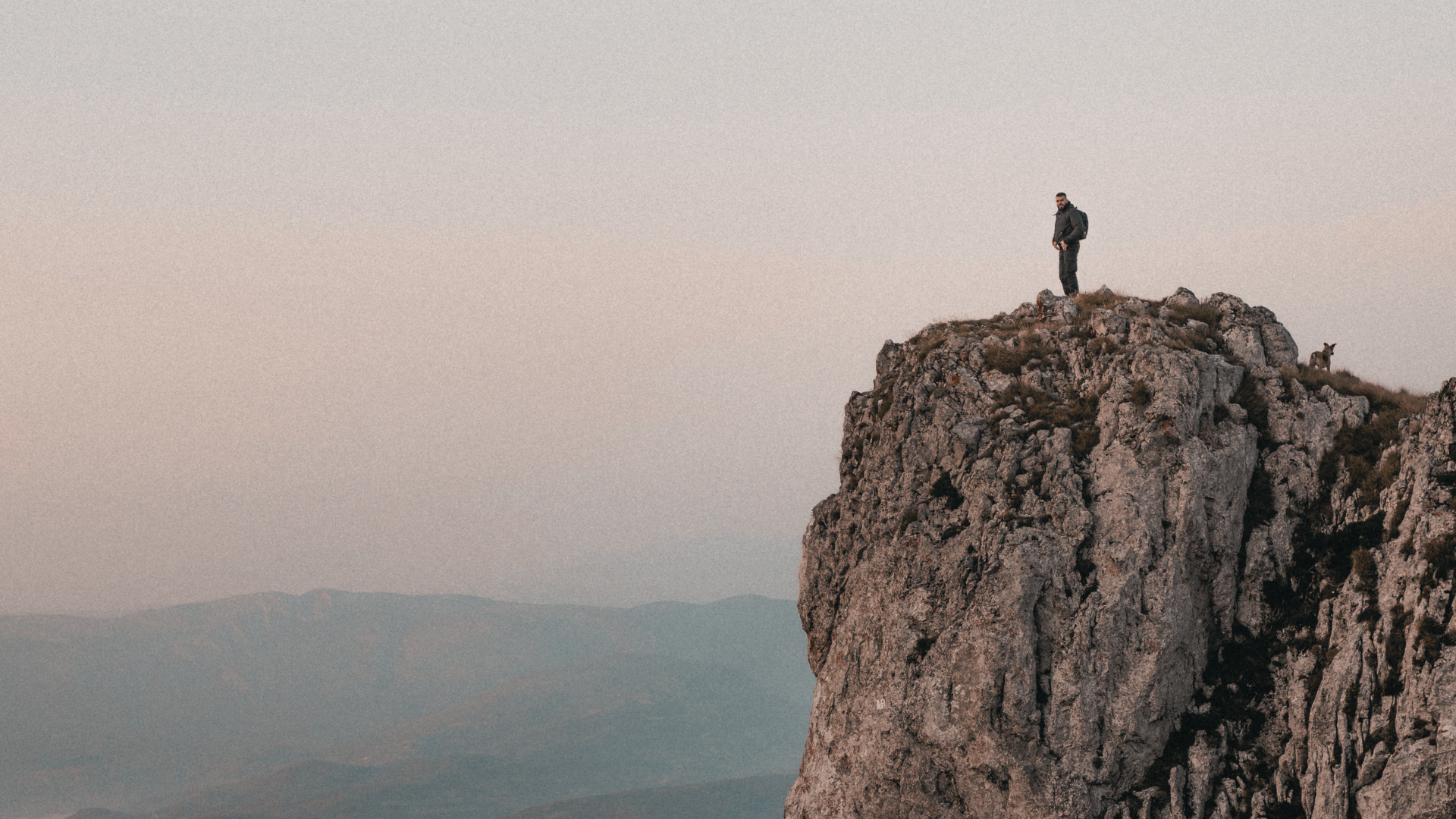 A lone climber on a mountain face — the founder navigating the route ahead